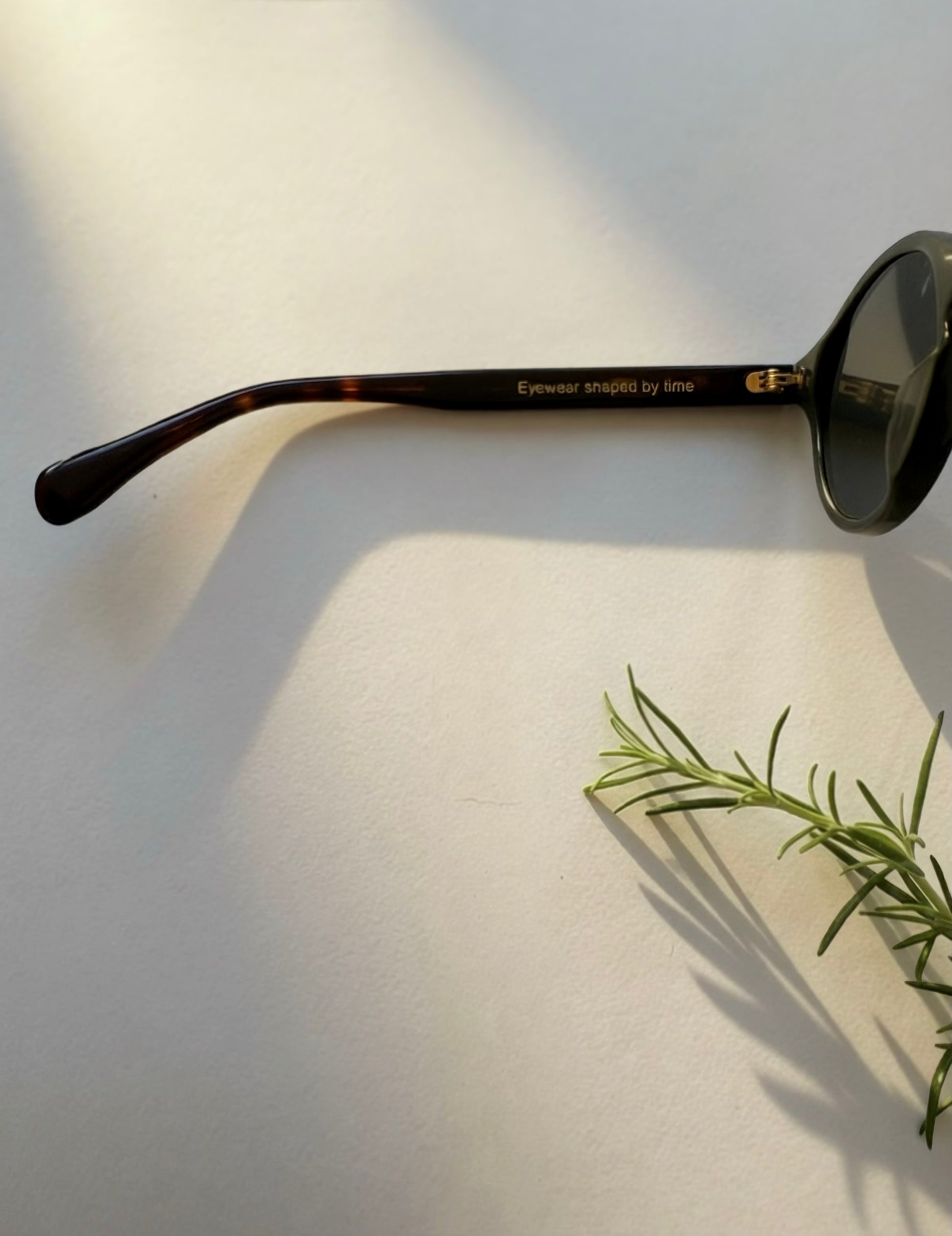 Side profile of Archive No.3 olive green sunglasses featuring Eyewear Shaped by Time temple engraving and premium craftsmanship.